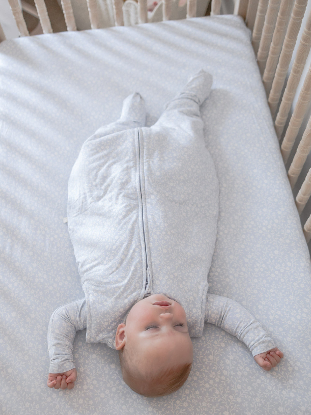 Light blue patterned footie sleep sack with full-length zipper and covered feet