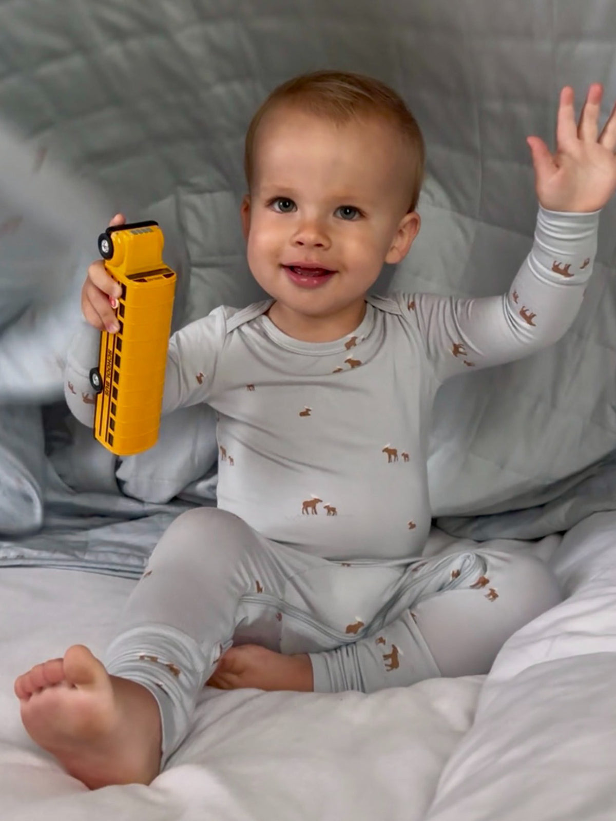 Light gray baby pajama set with long sleeves and moose print, cuffed legs
