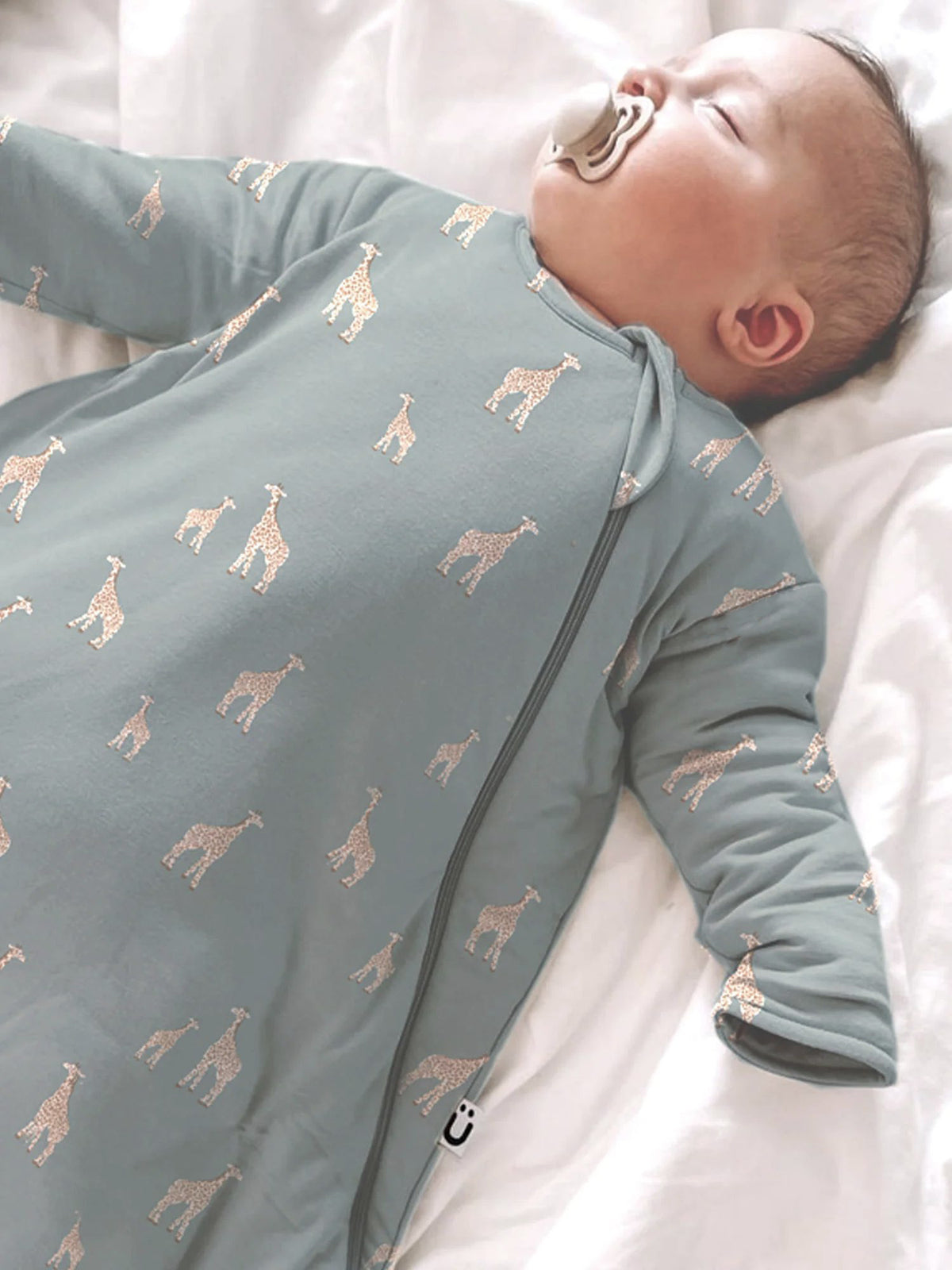 Long-sleeve sleep sack in moss green with allover giraffe print and zipper front