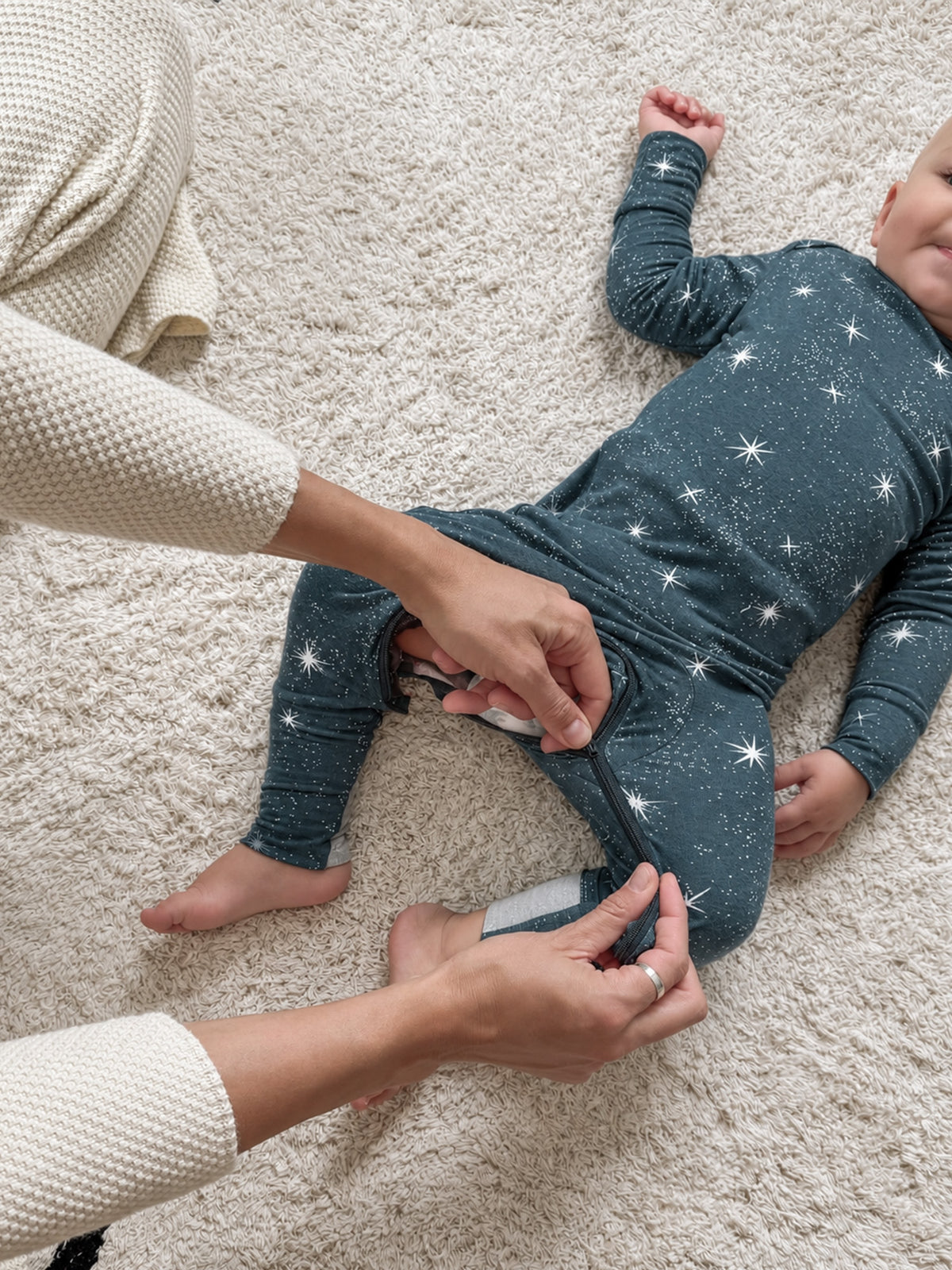 Infant convertible pajama in dark navy with white stars, folded legs for easy change