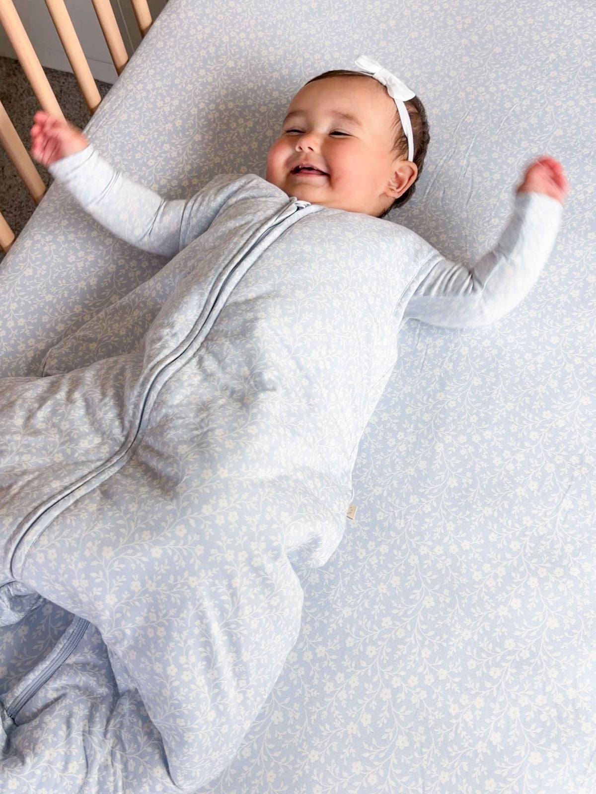 Light blue patterned 2.5 TOG footie sleep sack with full-length zipper and hood