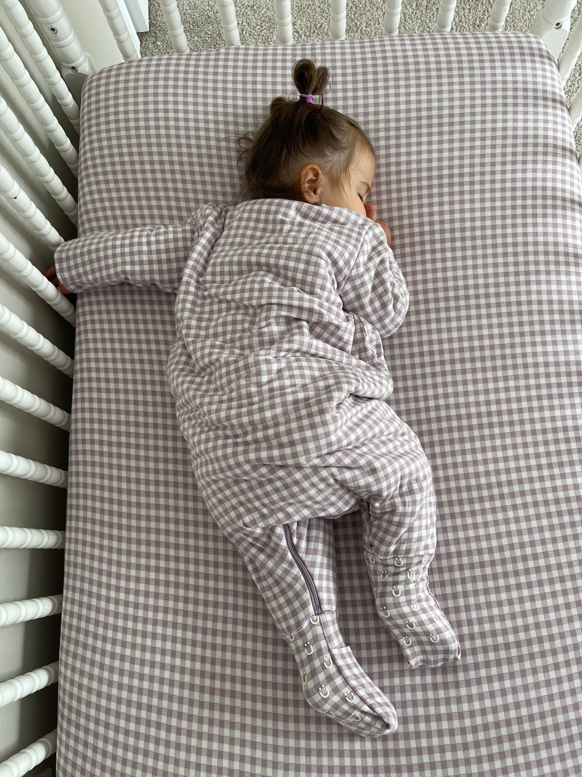 Infant long-sleeve footed sleep sack with hood, back view, gray-and-white check print
