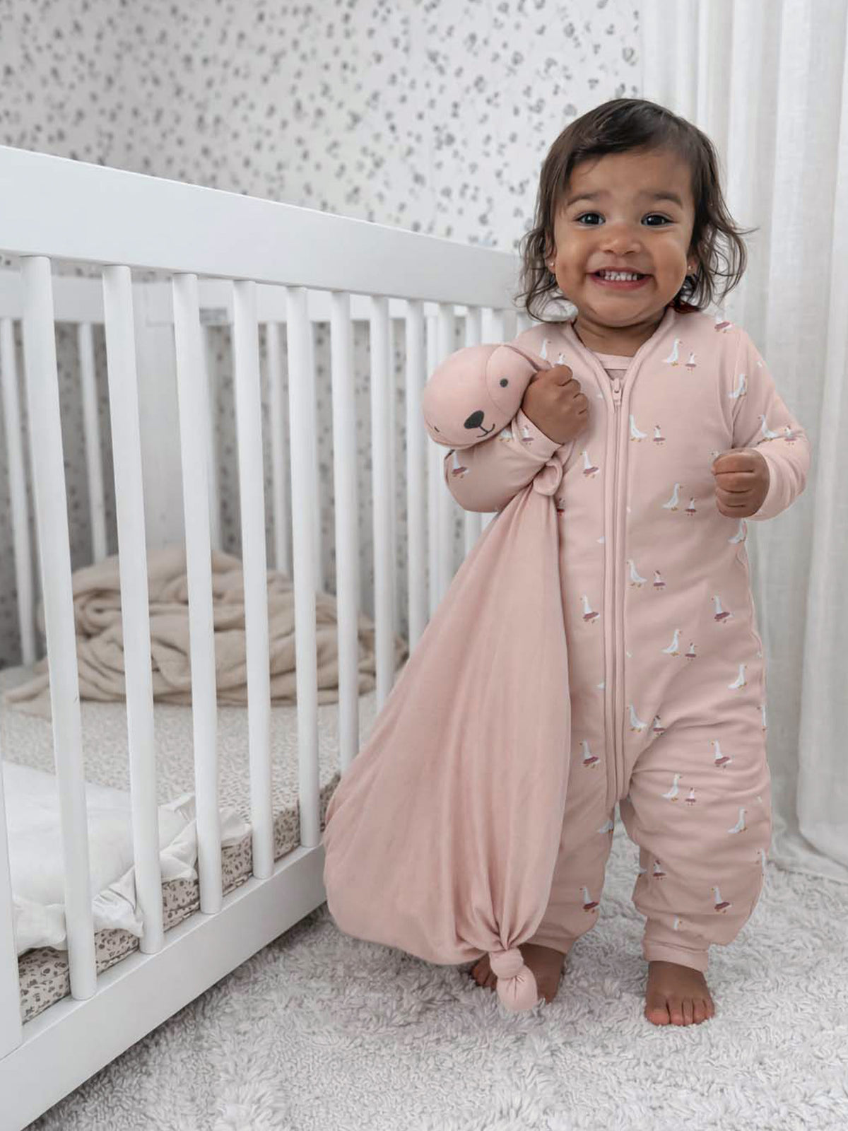 Light pink long-sleeve footie sleep sack with goose print and front zipper