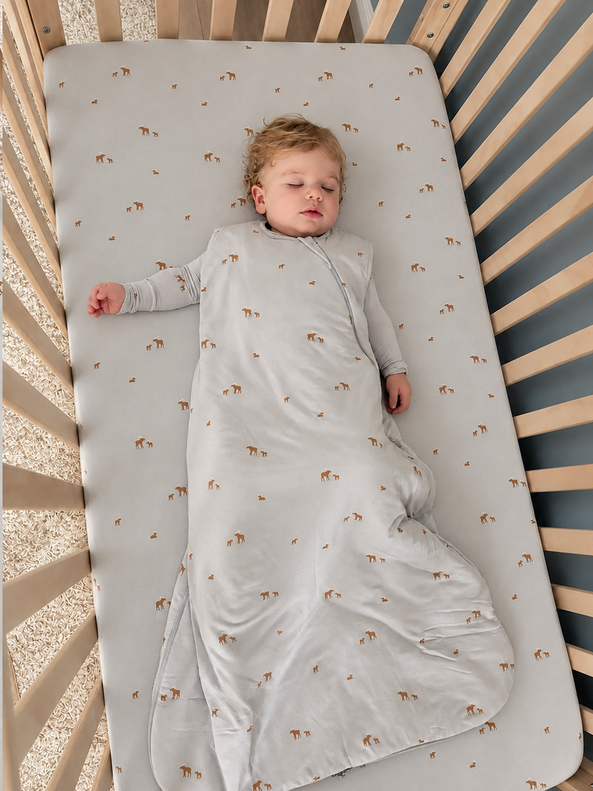 Light gray crib sheet featuring scattered moose motifs