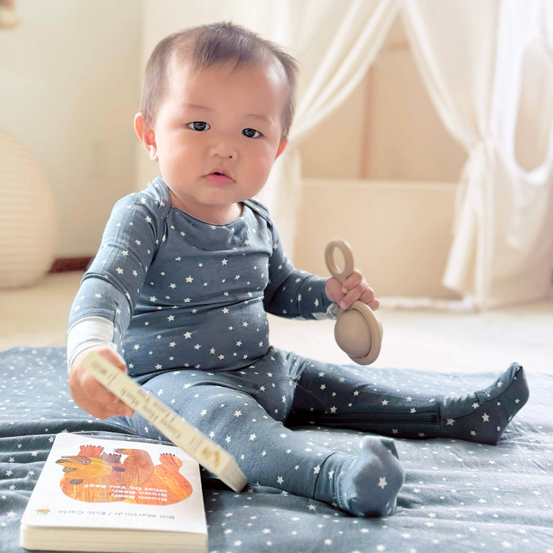 Navy star-print long-sleeve convertible pajama, toddler seated and holding book
