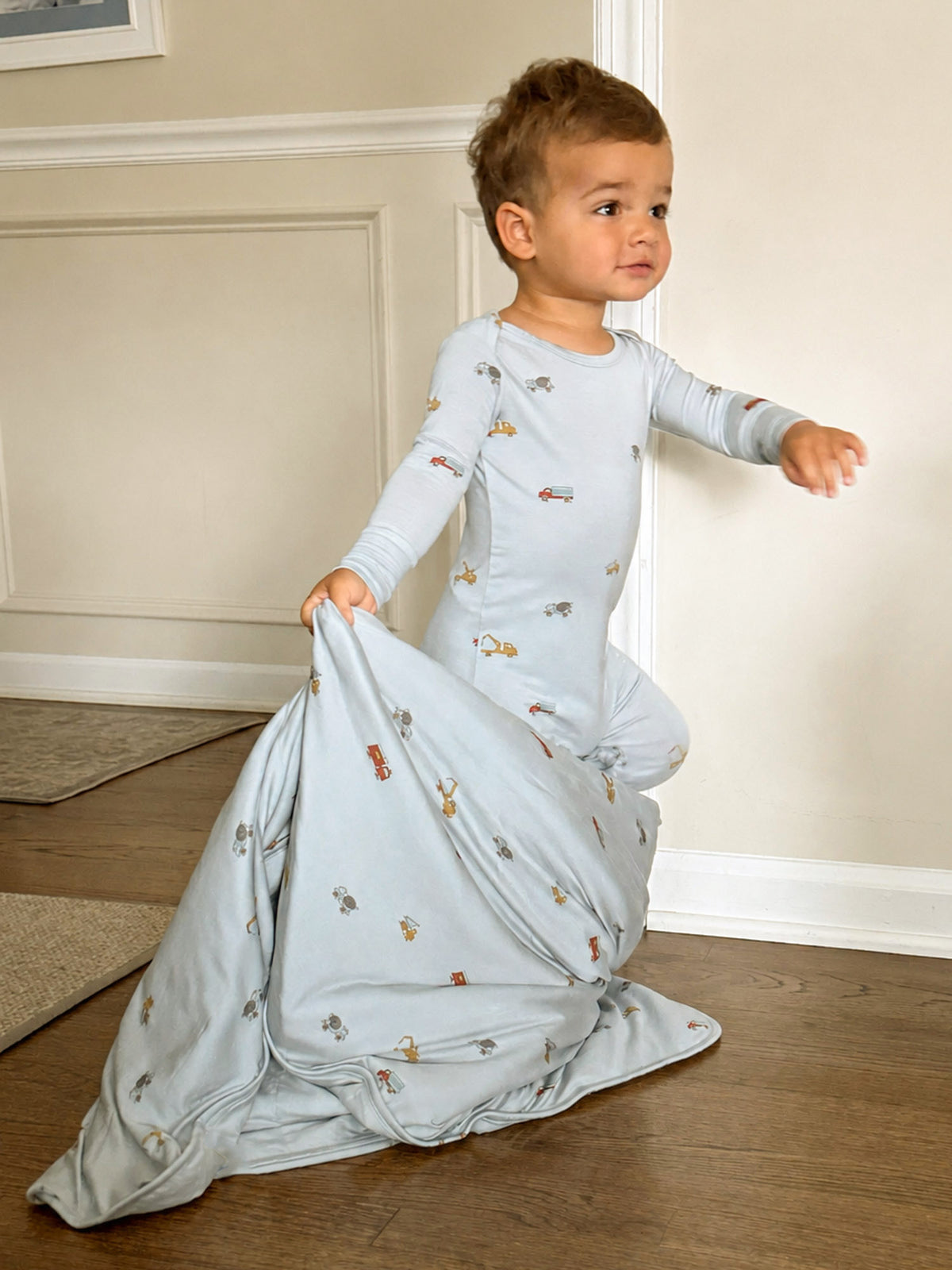Light blue 2.5 TOG blanket with vehicle print and wrapped cocoon opening