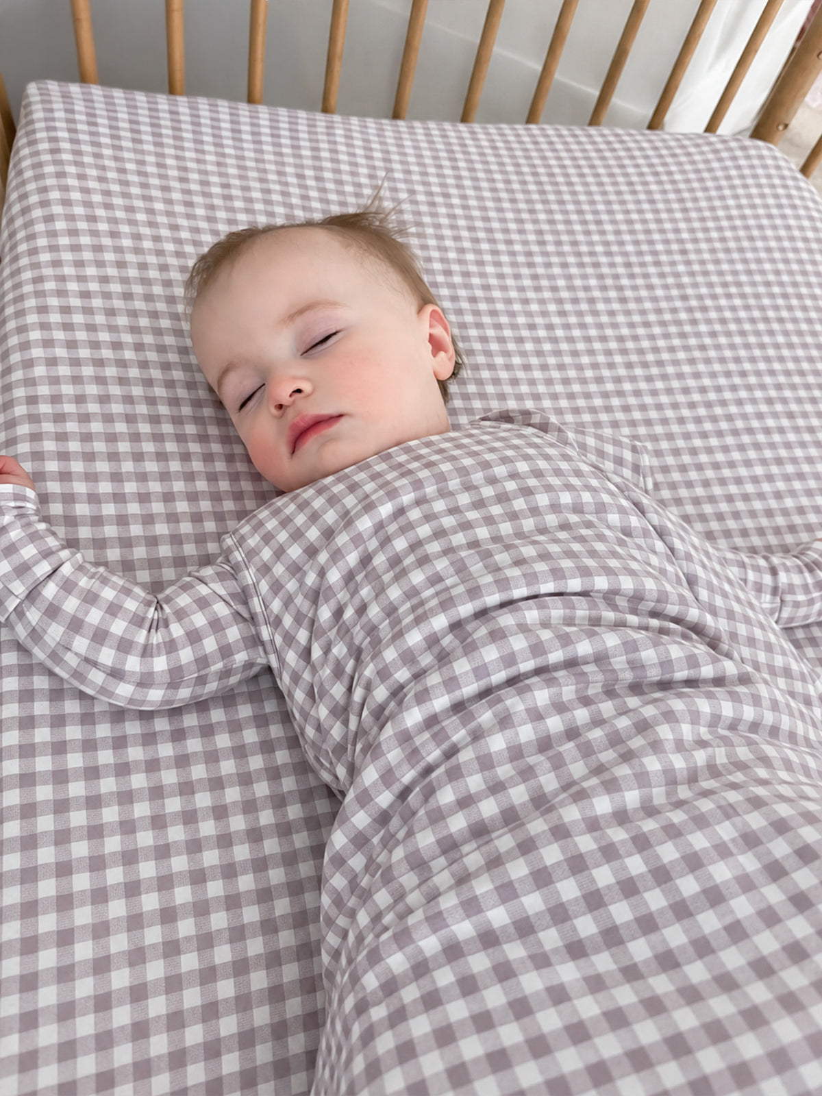 Baby sleep sack, gray-and-white gingham, long sleeves, worn by baby lying down, 2.5 TOG