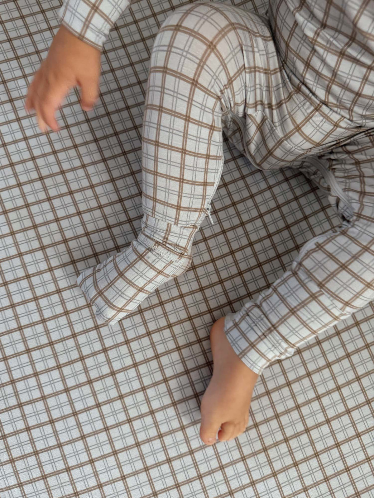 Cream plaid convertible pajama with long pant legs and elastic cuffs