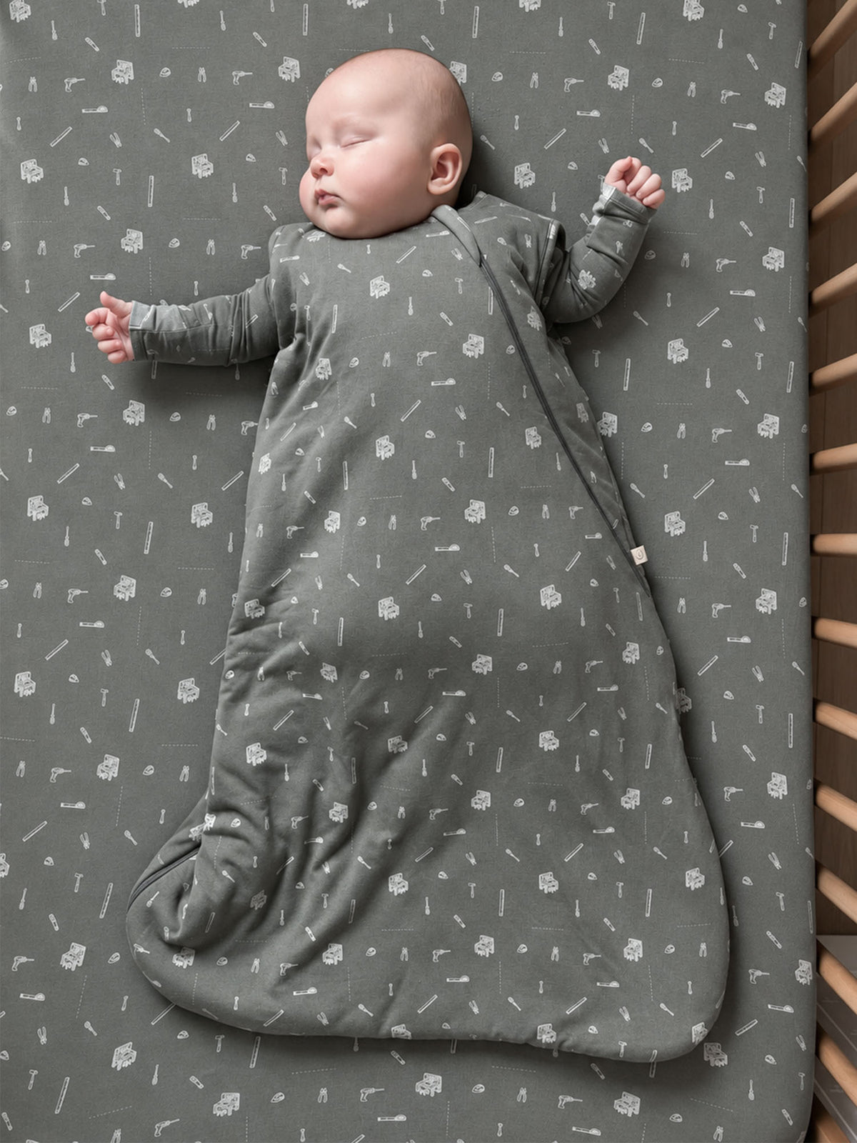 Dark gray 1.0 TOG sleep sack with white tool icons, full body with long sleeves