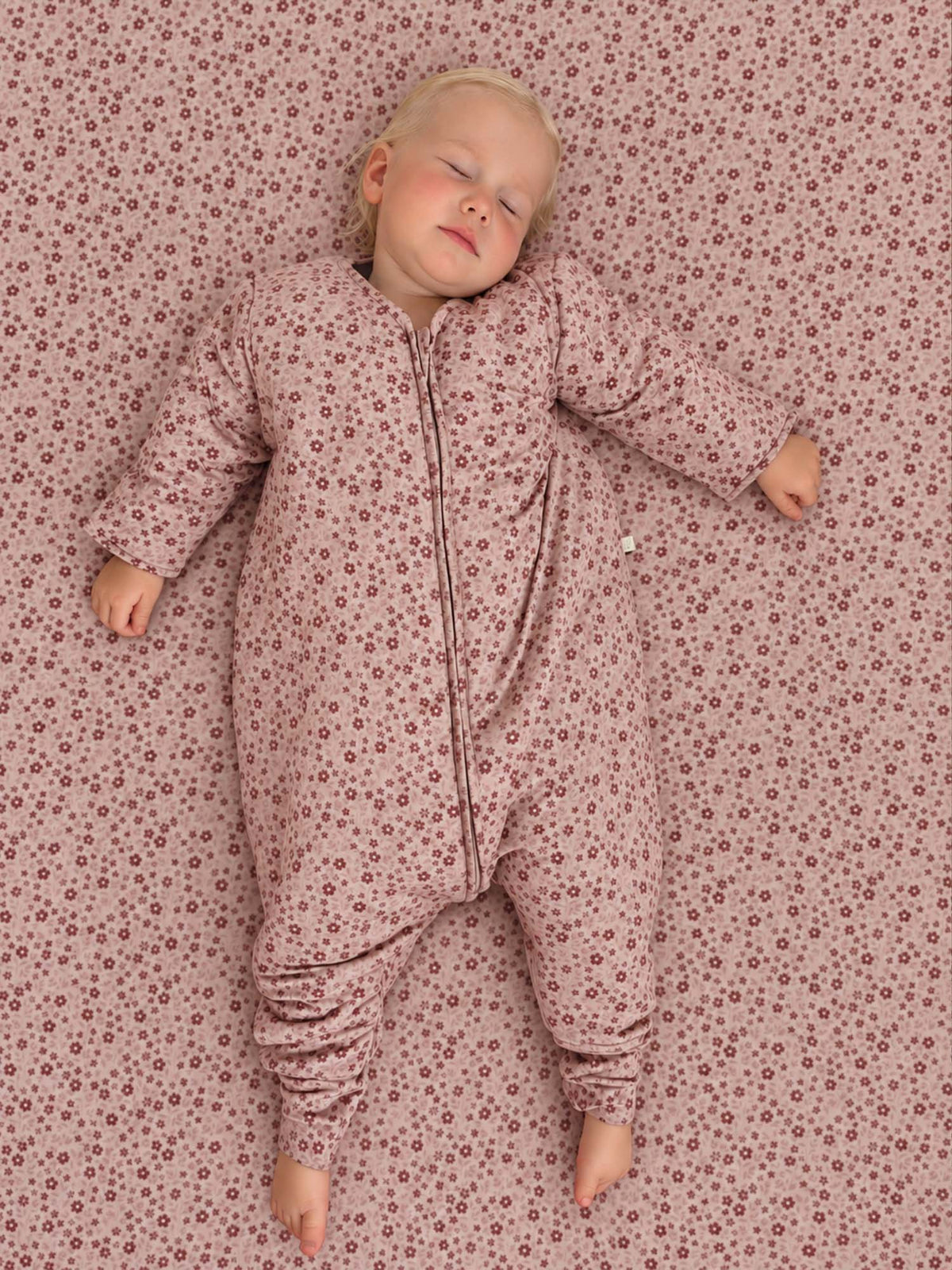 Pink heart-print long-sleeve footed sleep sack with front zipper, cuffed sleeves