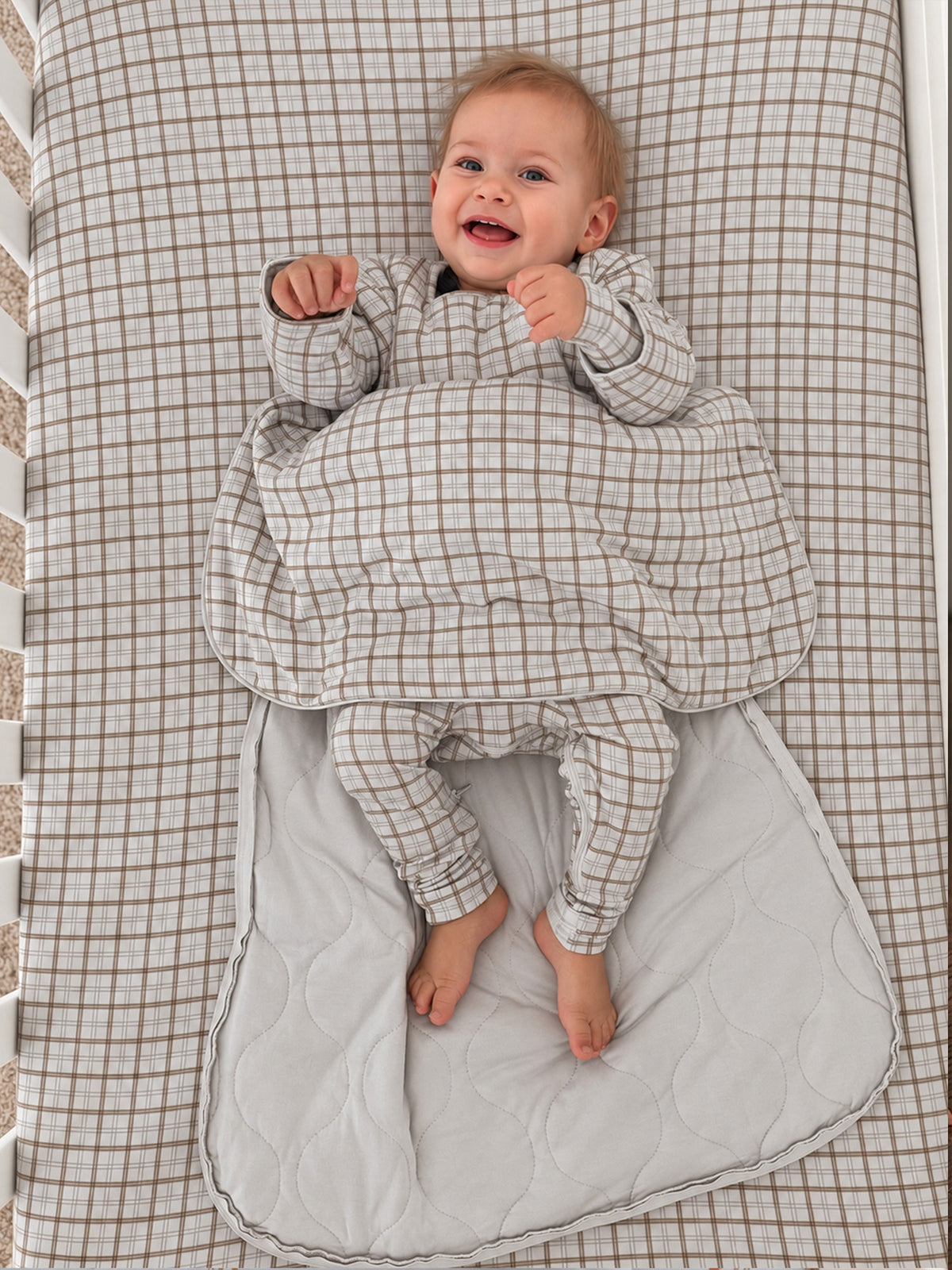 Plaid long-sleeve sleep sack with round neckline and padded bottom, light gray grid