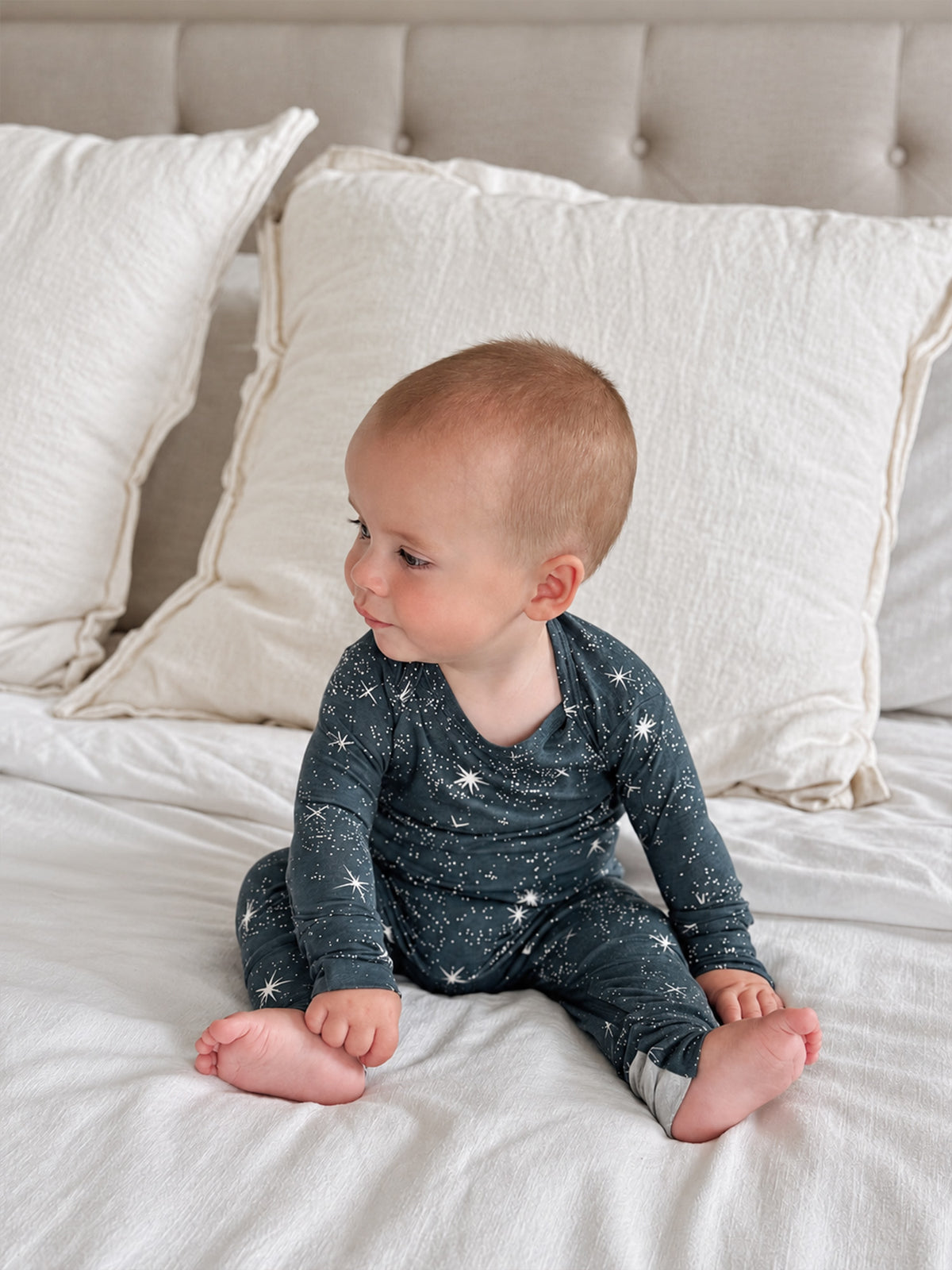 Infant convertible pajama in dark navy with white stars, long sleeves and cuffed pant legs