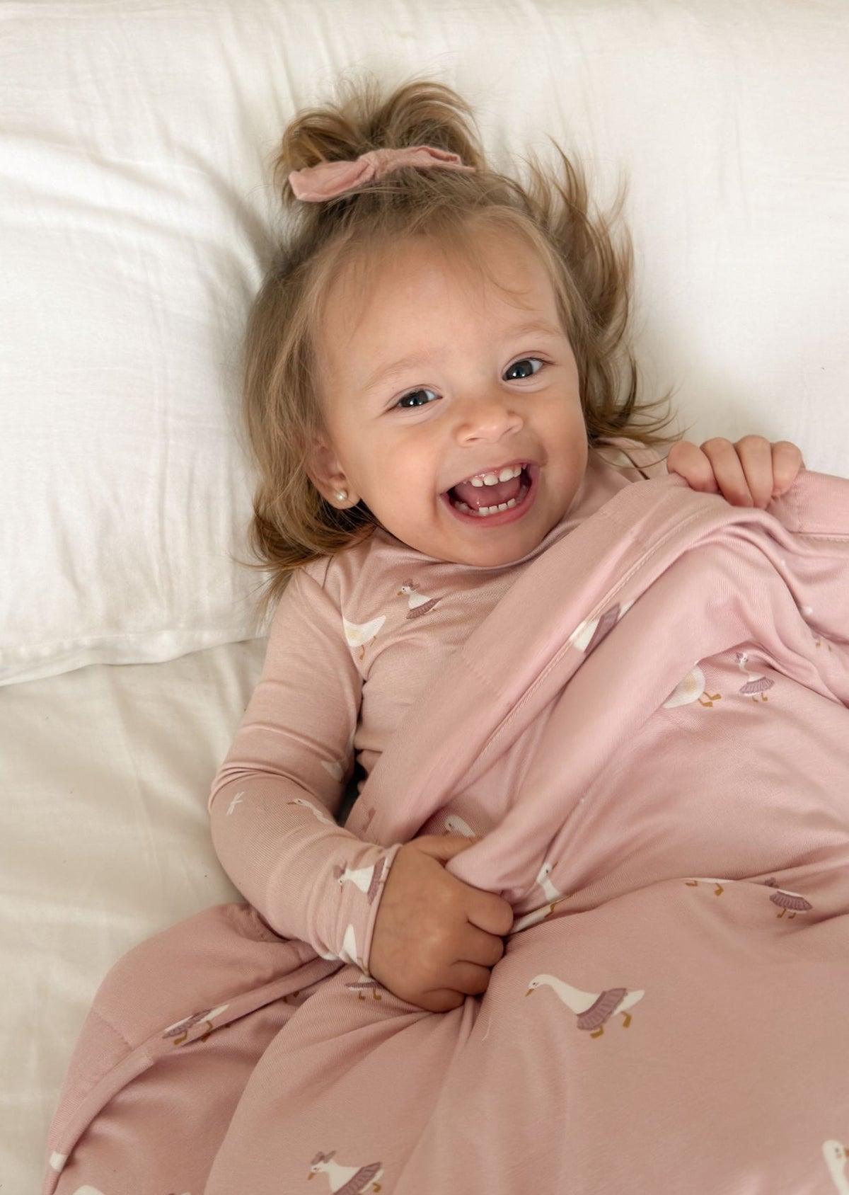 Light pink baby blanket with small bird print, soft breathable fabric