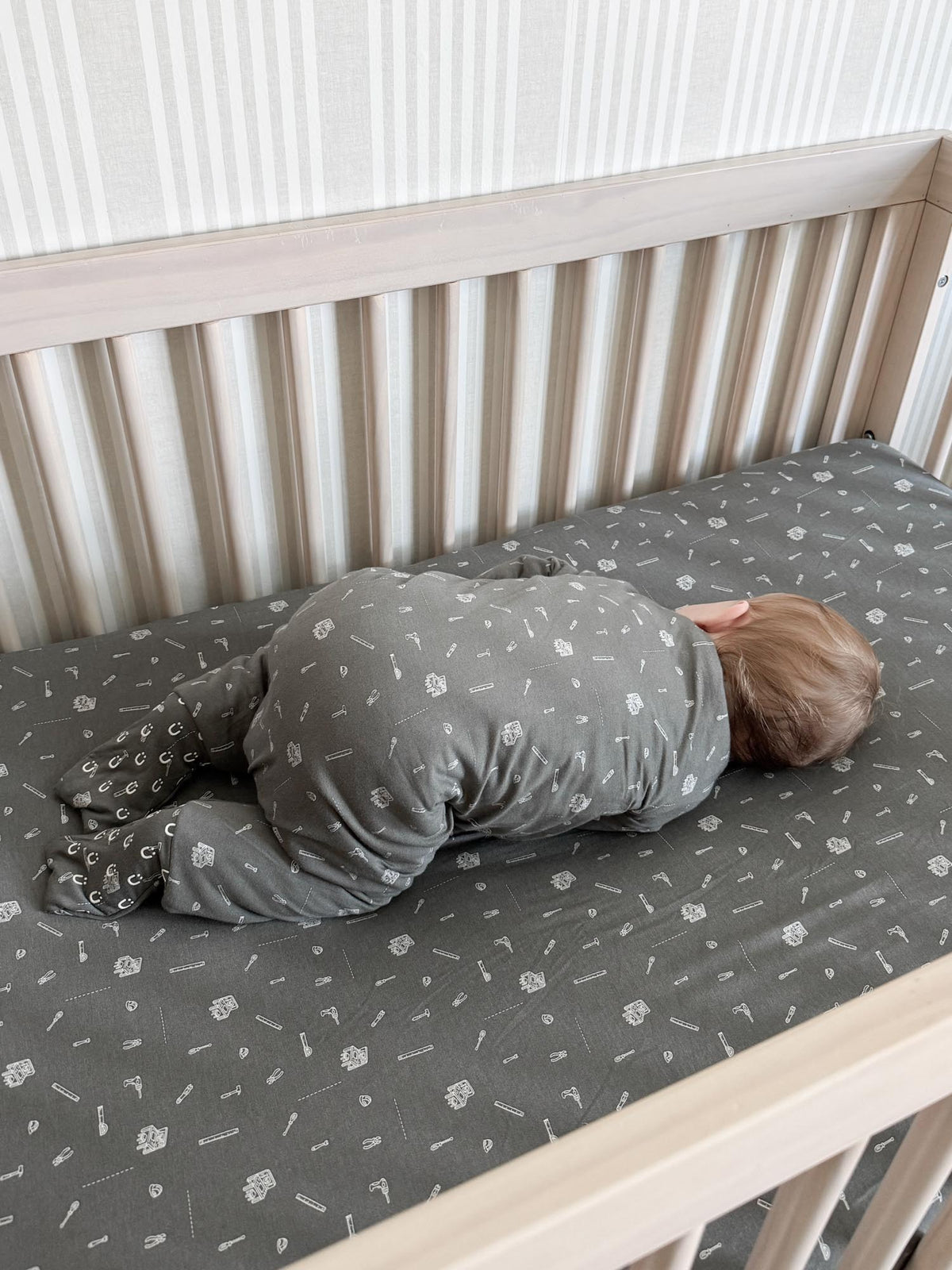 Gray footed sleep sack with white tool icon print