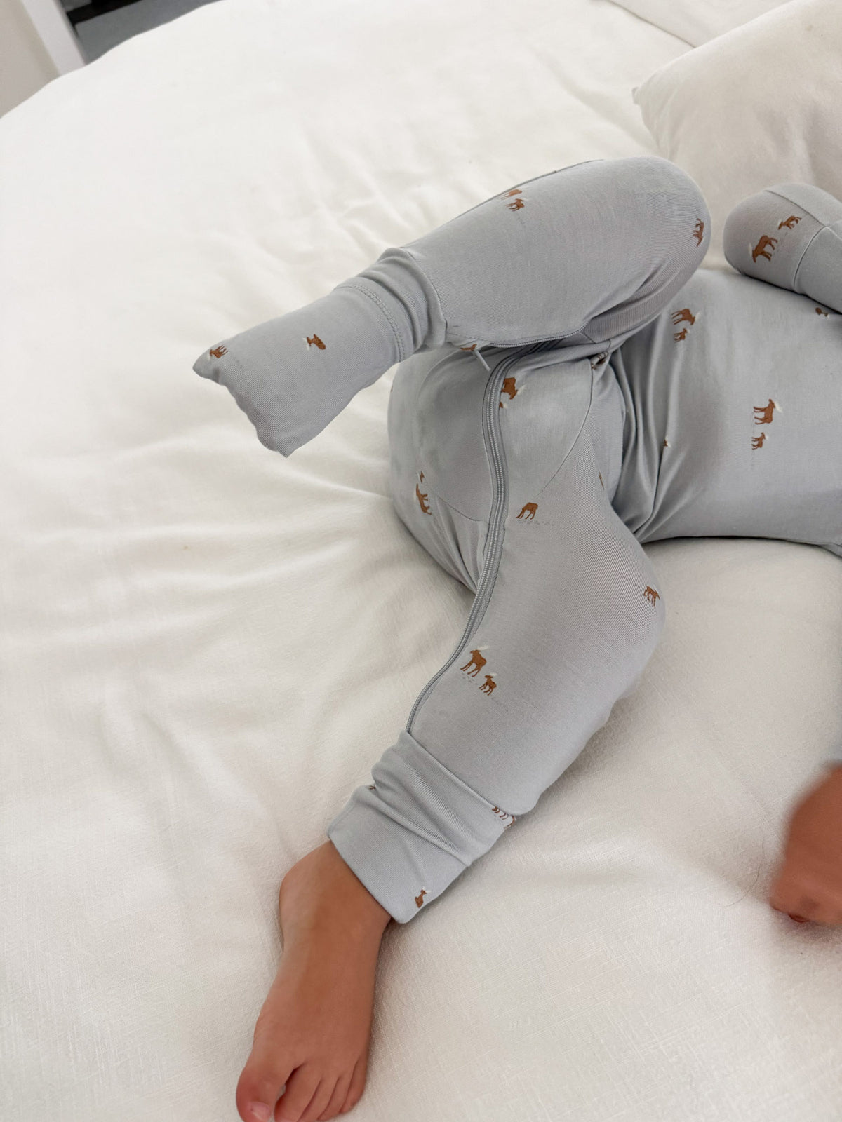 Light gray baby pajama set with moose print, long sleeves and snug ankle cuffs