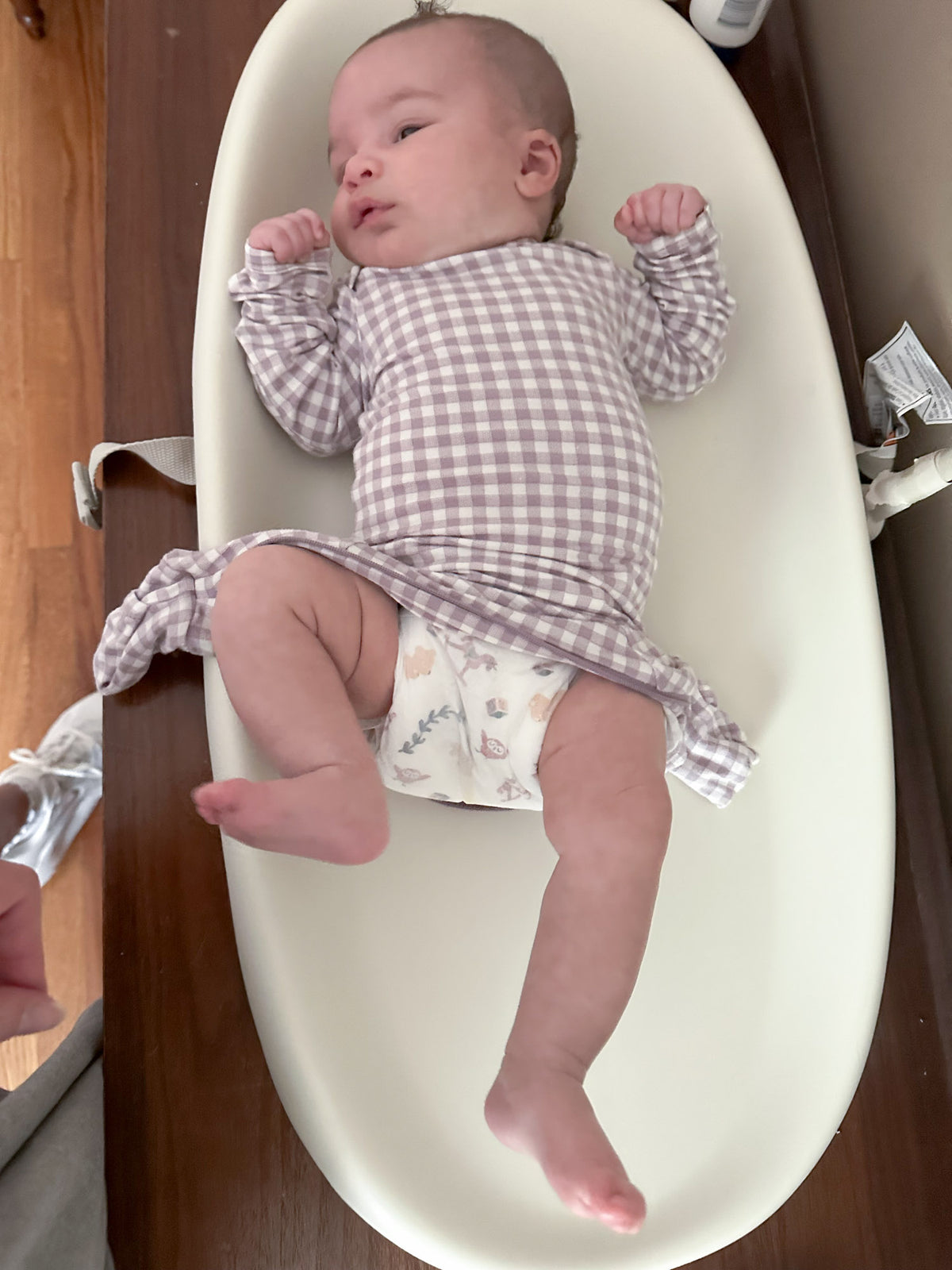 Gingham plaid baby pajama one-piece with long sleeves and footed pant legs